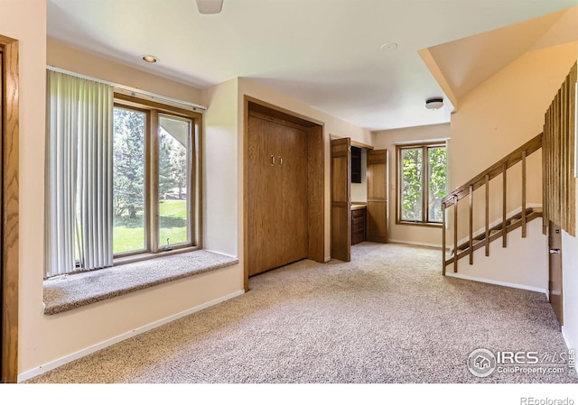 7975 Anchor Dr, Longmont, CO 80504 - entrance foyer with carpet flooring and stairs