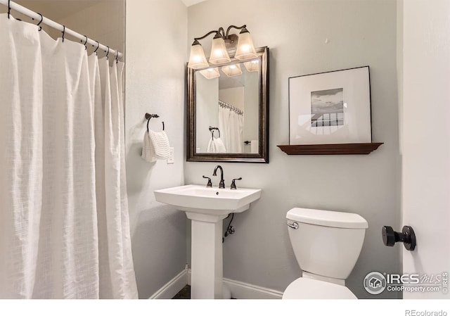 7975 Anchor Dr, Longmont, CO 80504 - bathroom featuring toilet and curtained shower