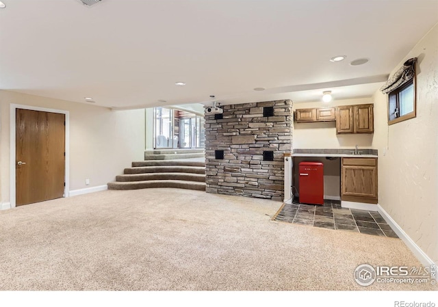7975 Anchor Dr, Longmont, CO 80504 - unfurnished living room featuring carpet floors and stairway