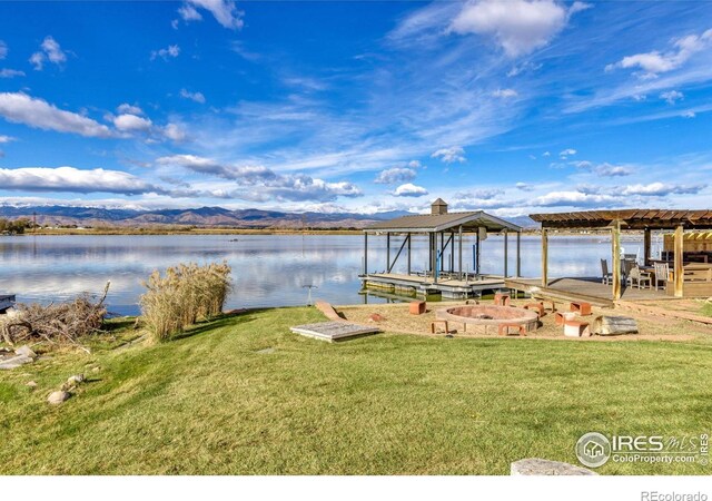 7975 Anchor Dr, Longmont, CO 80504 - dock with boat lift, a water and mountain view, and a yard