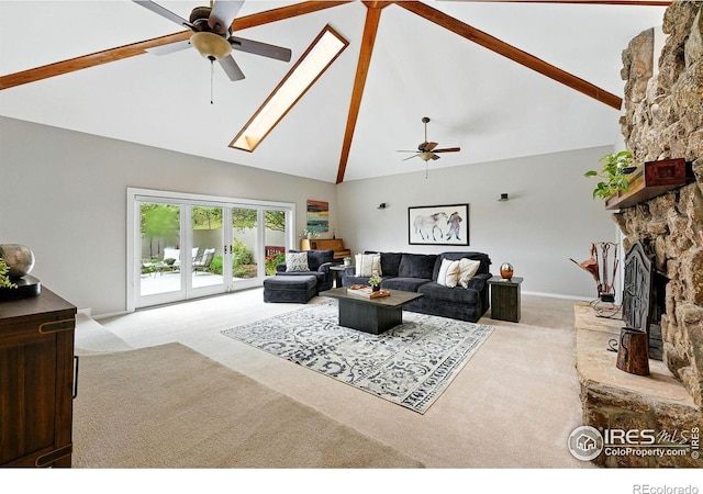178 Balsam Ln, Boulder, CO 80304 - living room featuring ceiling fan, carpet flooring, high vaulted ceiling, a stone fireplace, and a skylight