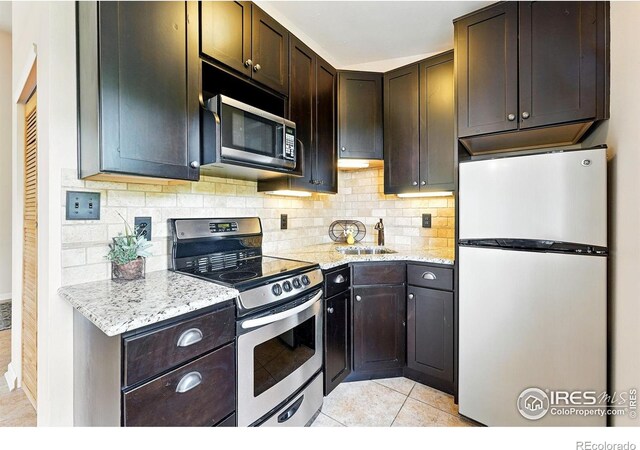178 Balsam Ln, Boulder, CO 80304 - kitchen with appliances with stainless steel finishes, light tile patterned floors, backsplash, and dark brown cabinetry
