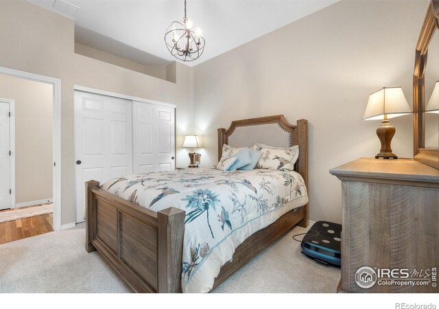 1976 Cayman Dr, Windsor, CO 80550 - bedroom with carpet floors, a closet, and a chandelier