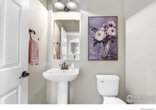1976 Cayman Dr, Windsor, CO 80550 - half bath featuring toilet and a sink