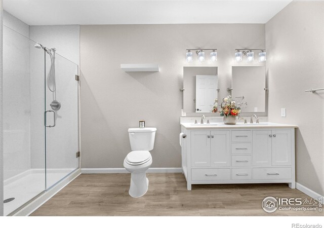 1976 Cayman Dr, Windsor, CO 80550 - full bathroom with wood finished floors, double vanity, and a stall shower