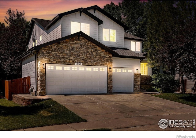1662 Crestview Ln, Erie, CO 80516 - view of front of home featuring stone siding, driveway, a garage, and board and batten siding