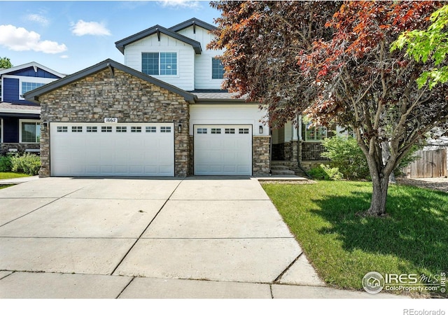 1662 Crestview Ln, Erie, CO 80516 - view of front of house featuring stone siding, driveway, and an attached garage