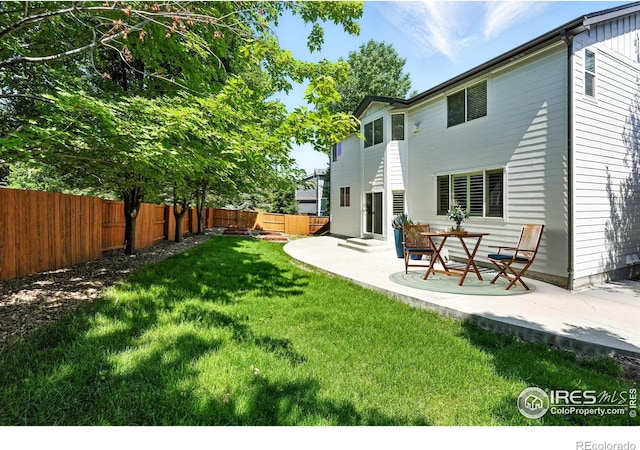 1662 Crestview Ln, Erie, CO 80516 - fenced backyard featuring a patio area
