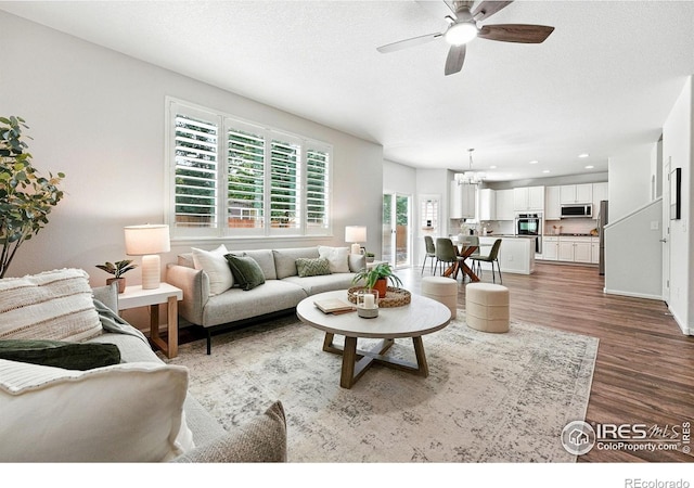 1662 Crestview Ln, Erie, CO 80516 - living room with wood finished floors, a ceiling fan, recessed lighting, and a chandelier