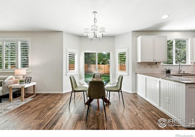 1662 Crestview Ln, Erie, CO 80516 - dining room featuring dark wood-type flooring and a chandelier