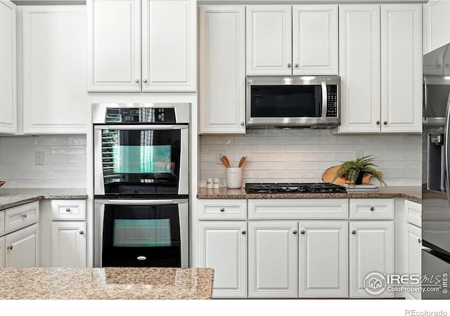 1662 Crestview Ln, Erie, CO 80516 - kitchen with stainless steel appliances and white cabinets