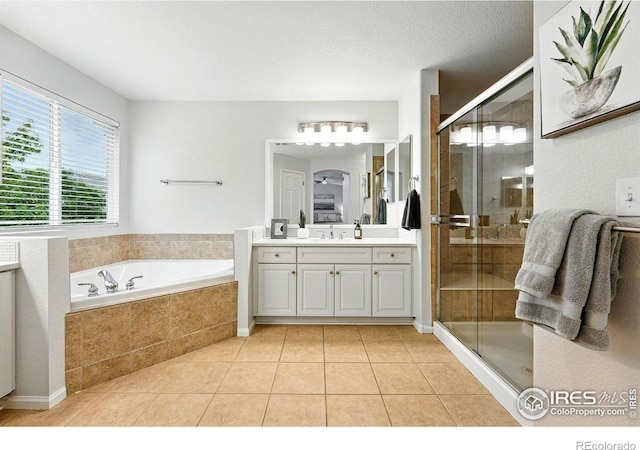 1662 Crestview Ln, Erie, CO 80516 - full bath featuring vanity, a bath, tile patterned flooring, and a shower stall