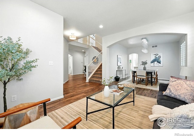 1662 Crestview Ln, Erie, CO 80516 - living room featuring arched walkways, stairs, wood finished floors, and recessed lighting
