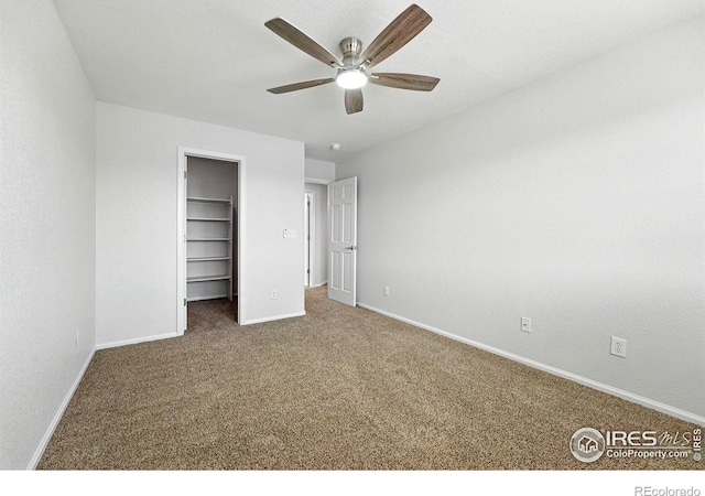 1662 Crestview Ln, Erie, CO 80516 - unfurnished bedroom featuring carpet floors, a walk in closet, ceiling fan, and a closet