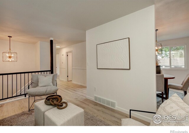 1206 Dawn Ave, Gilcrest, CO 80623 - living room featuring a chandelier and light wood finished floors