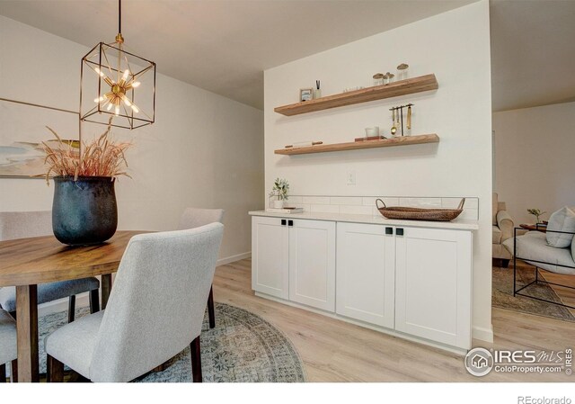 1206 Dawn Ave, Gilcrest, CO 80623 - dining room featuring light wood-style flooring and a chandelier