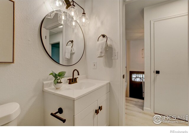 1206 Dawn Ave, Gilcrest, CO 80623 - bathroom featuring wood finished floors and vanity