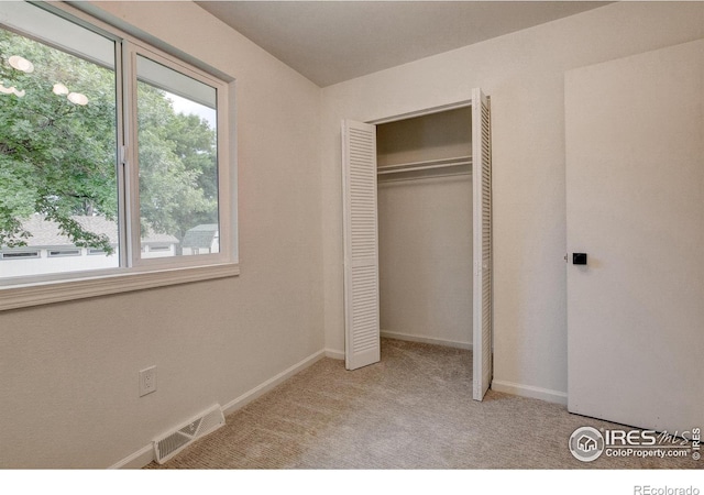 1206 Dawn Ave, Gilcrest, CO 80623 - unfurnished bedroom with multiple windows, carpet flooring, and a closet