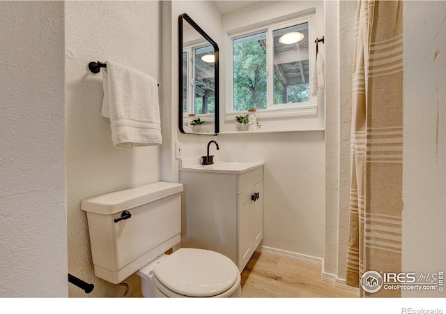 1206 Dawn Ave, Gilcrest, CO 80623 - bathroom featuring vanity, wood finished floors, and a textured wall
