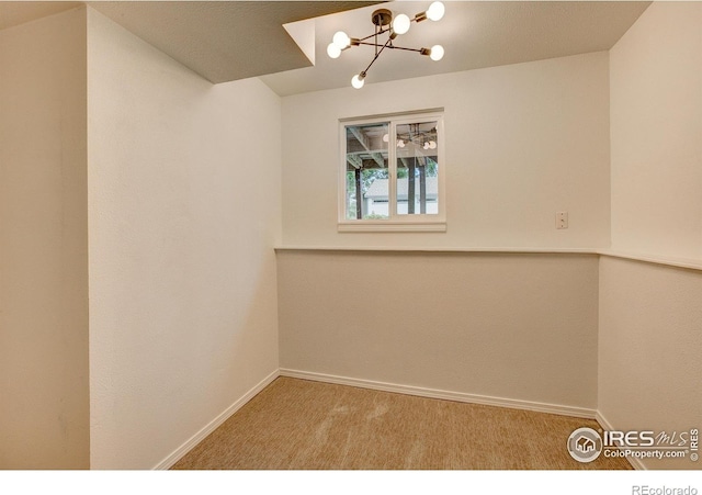1206 Dawn Ave, Gilcrest, CO 80623 - carpeted spare room with a chandelier and baseboards