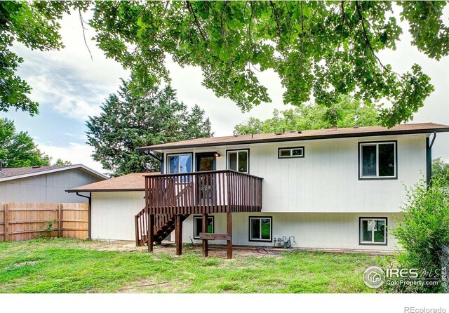 1206 Dawn Ave, Gilcrest, CO 80623 - rear view of property with stairway and a wooden deck