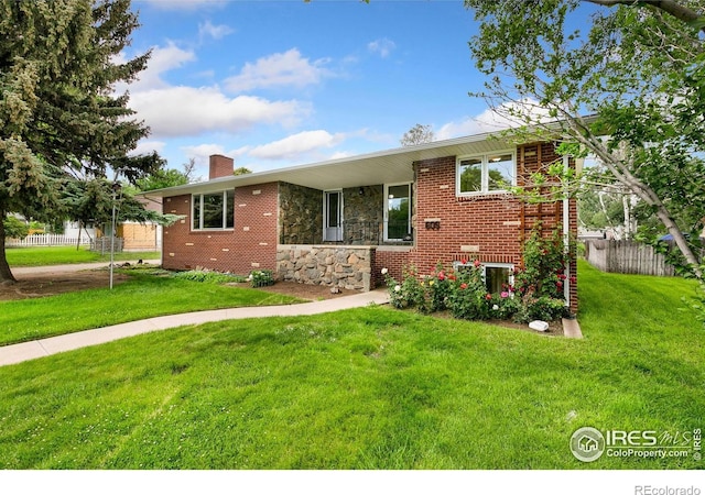 609 Endicott St, Fort Collins, CO 80524 - view of front of house featuring a chimney, stone siding, and brick siding