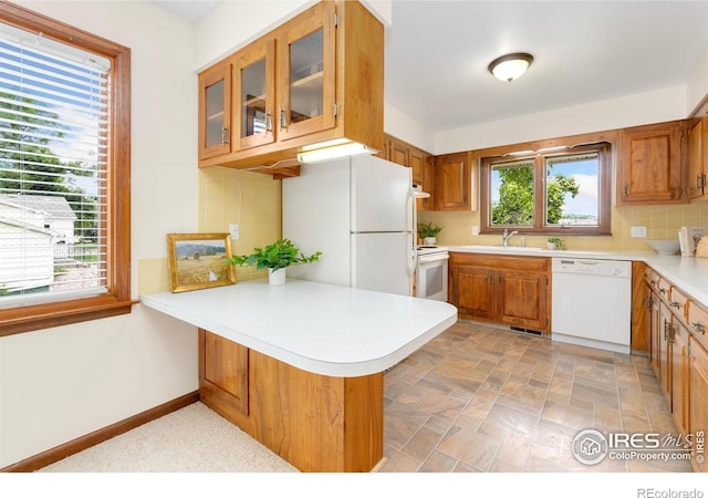609 Endicott St, Fort Collins, CO 80524 - kitchen featuring white appliances, a peninsula, tasteful backsplash, and brown cabinets