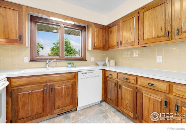 609 Endicott St, Fort Collins, CO 80524 - kitchen featuring dishwasher, brown cabinets, and light countertops