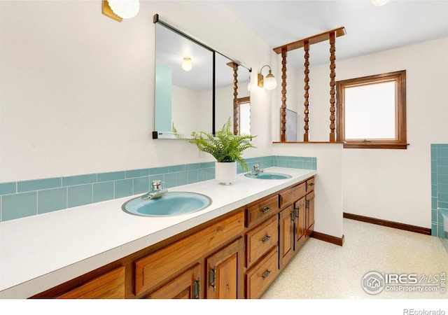 609 Endicott St, Fort Collins, CO 80524 - bathroom featuring double vanity and baseboards