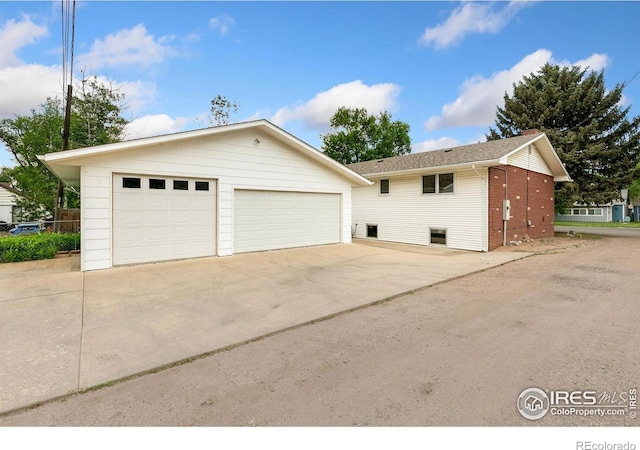 609 Endicott St, Fort Collins, CO 80524 - view of home's exterior with a detached garage, an outdoor structure, and brick siding