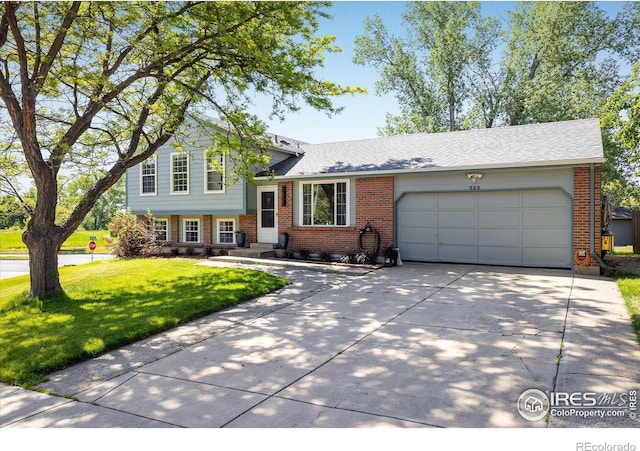 322 W Harper St, Louisville, CO 80027 - split level home with brick siding, concrete driveway, an attached garage, and a front lawn