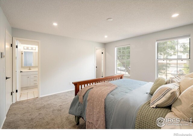 322 W Harper St, Louisville, CO 80027 - carpeted bedroom featuring recessed lighting, connected bathroom, and a textured ceiling