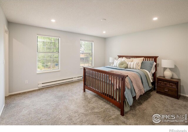 322 W Harper St, Louisville, CO 80027 - carpeted bedroom featuring a baseboard radiator, recessed lighting, and a textured ceiling