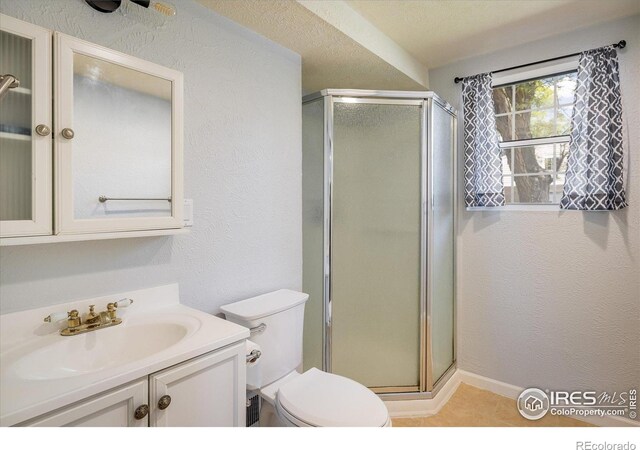 322 W Harper St, Louisville, CO 80027 - full bathroom featuring a stall shower, vanity, and tile patterned floors