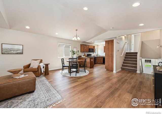 1879 Gemini Ct, Loveland, CO 80537 - living area featuring light wood-type flooring, a chandelier, stairway, lofted ceiling, and recessed lighting