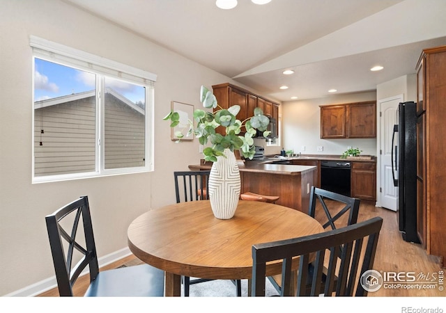 1879 Gemini Ct, Loveland, CO 80537 - dining area with light wood-style floors, vaulted ceiling, and recessed lighting