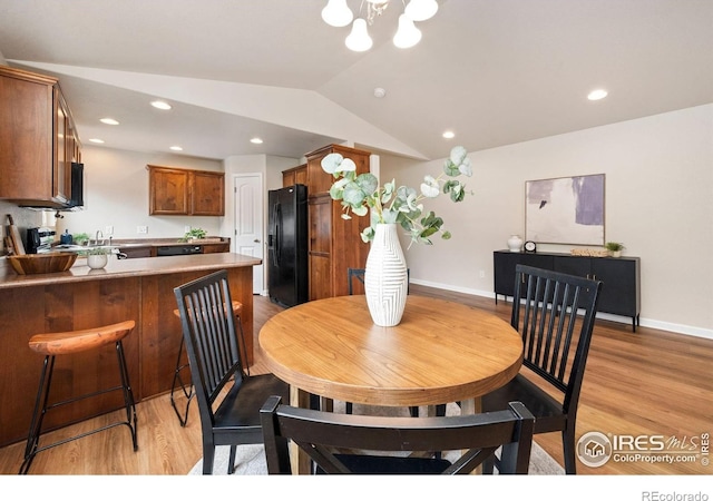 1879 Gemini Ct, Loveland, CO 80537 - dining space featuring lofted ceiling, light wood-style flooring, recessed lighting, and a chandelier