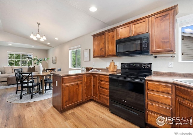 1879 Gemini Ct, Loveland, CO 80537 - kitchen featuring black appliances, light wood-type flooring, a peninsula, healthy amount of natural light, and recessed lighting