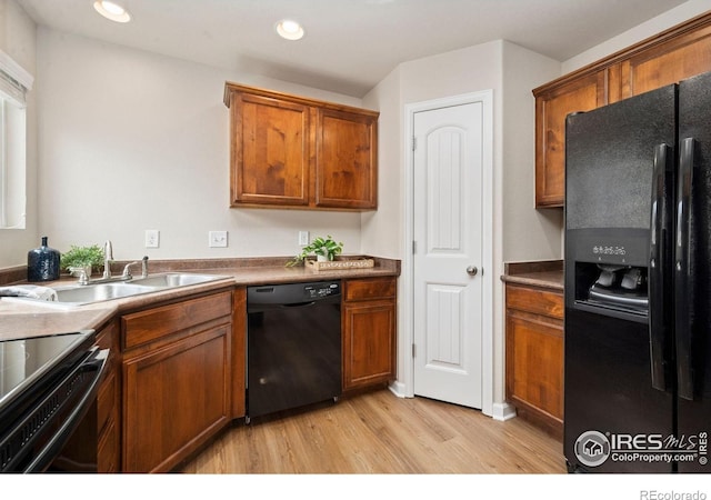 1879 Gemini Ct, Loveland, CO 80537 - kitchen featuring black appliances, light wood finished floors, brown cabinets, and recessed lighting