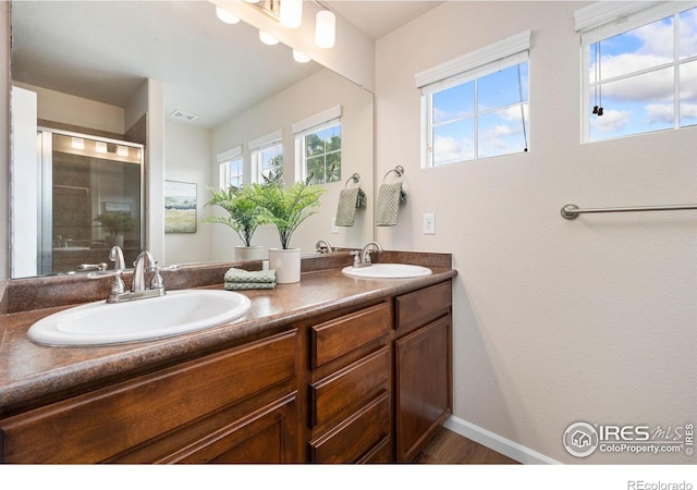 1879 Gemini Ct, Loveland, CO 80537 - full bathroom with double vanity and a shower with door