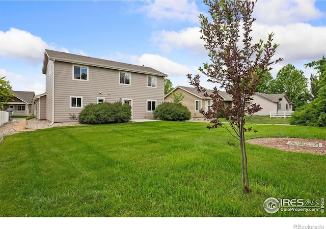 1879 Gemini Ct, Loveland, CO 80537 - rear view of property featuring a yard