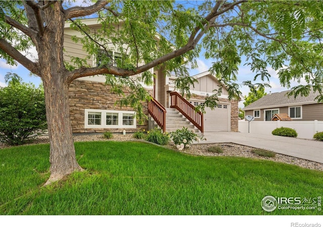 1879 Gemini Ct, Loveland, CO 80537 - view of front of house featuring stone siding, driveway, stairway, and an attached garage