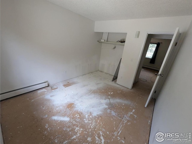2919 Riverside Dr, Idaho Springs, CO 80452 - unfurnished bedroom with baseboard heating, a closet, and a textured ceiling