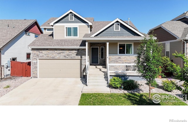 1661 Rise Dr, Windsor, CO 80550 - craftsman house with a porch, driveway, stone siding, and a shingled roof