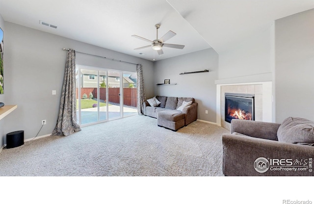 1661 Rise Dr, Windsor, CO 80550 - living room featuring carpet flooring, a tile fireplace, and ceiling fan