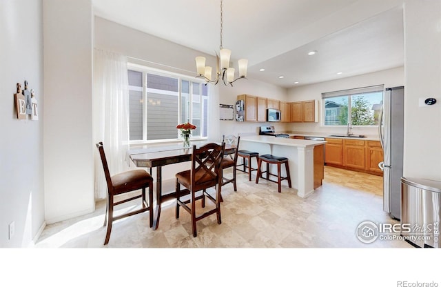 1661 Rise Dr, Windsor, CO 80550 - dining room featuring a chandelier and recessed lighting