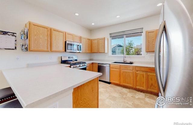 1661 Rise Dr, Windsor, CO 80550 - kitchen featuring stainless steel appliances, a peninsula, light brown cabinetry, recessed lighting, and light countertops