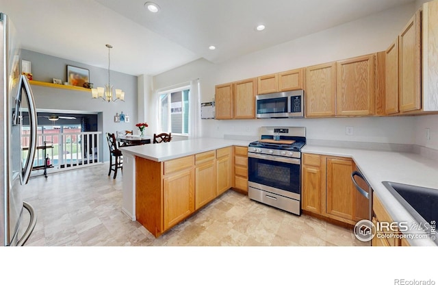 1661 Rise Dr, Windsor, CO 80550 - kitchen featuring stainless steel appliances, a chandelier, a peninsula, light countertops, and recessed lighting