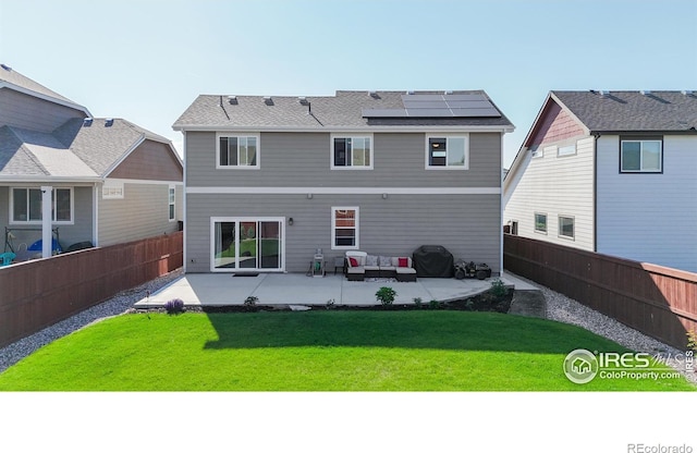1661 Rise Dr, Windsor, CO 80550 - back of house featuring a patio, roof mounted solar panels, a fenced backyard, and outdoor lounge area