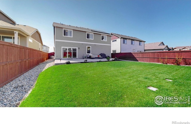 1661 Rise Dr, Windsor, CO 80550 - rear view of house with a patio and a fenced backyard